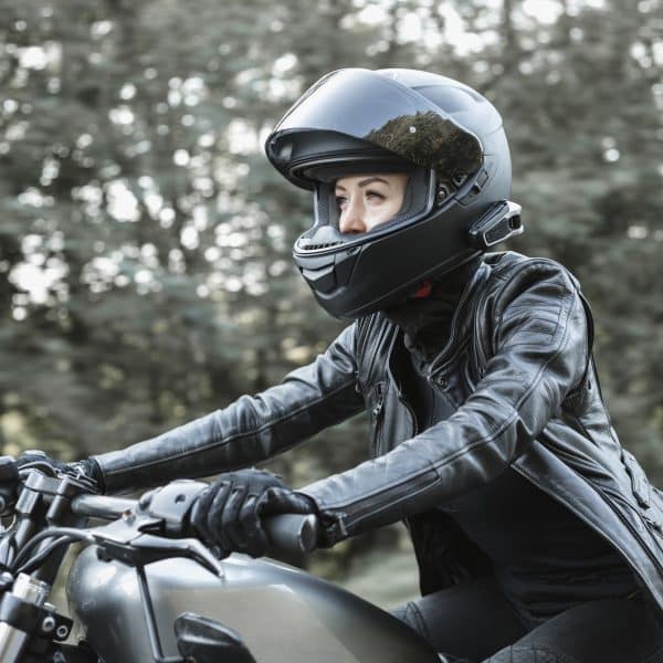 young woman driving motorcycle P36HZPE scaled